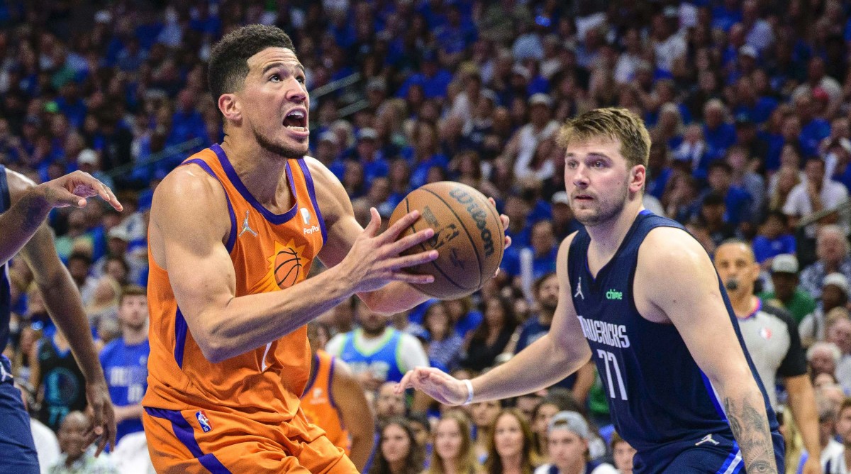 Phoenix Suns guard Devin Booker (1) and Mavericks guard Luka Doncic (77)